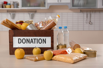 Donation box and different products on table indoors