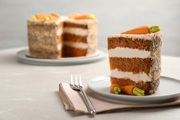 Sweet carrot cake with delicious cream on white table, space for text