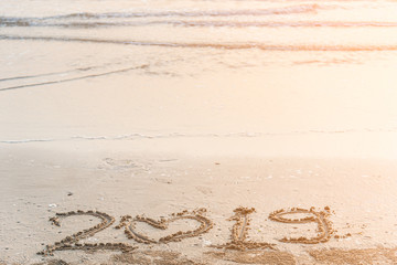 New Year 2019 is coming concept. wave coming to 2019 concept on the sand beach in the morning.