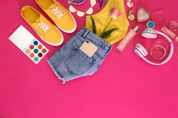 Flat lay composition with stylish summer clothes and accessories on pink background