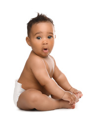 Adorable African-American baby in diaper on white background - obrazy, fototapety, plakaty
