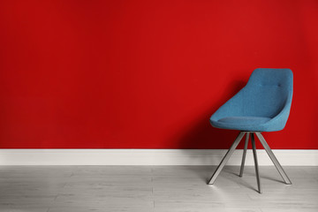 Blue modern chair for interior design on wooden floor at red wall
