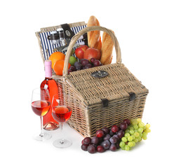 Wicker picnic basket with different products on white background