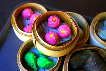 Tray of colorful Dim sum dumplings in a steam basket