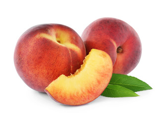 Sweet juicy peaches with leaves on white background