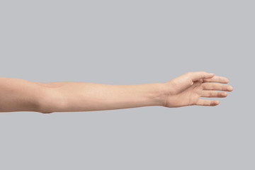 Young woman holding hand on grey background, closeup