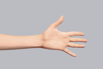 Young woman showing hand on grey background, closeup