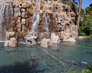  Cropped shot of water cascading from a waterfalls in a landscaped garden