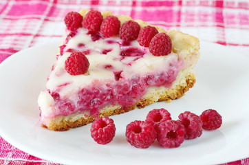 Raspberry pie with sour cream filling and raspberry berries on a plate