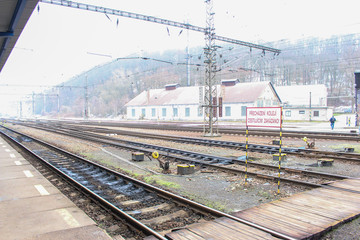 Fototapeta na wymiar The image of railway platform in a small country town in morning, Czech Republic. Translation : Track crossing. Traveling Prohibited!