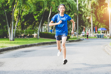 Asian women in sportswear in the park. The concept of living and sports for health.