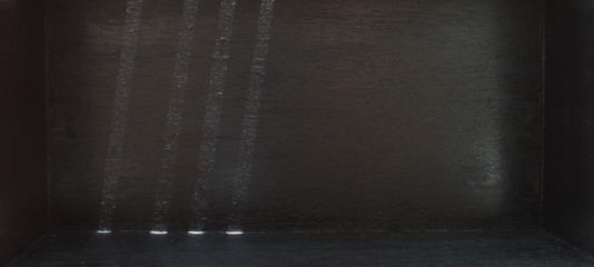 Fototapeta premium Light and shadow in a black room with empty space