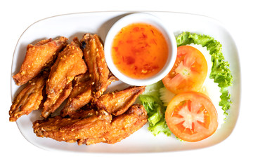 Fried chicken wings with chicken sauce on the dish. Isolated on white background. clipping paths