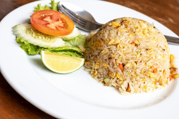 Fried rice with pork and vegetable on dish, Thai cuisine.