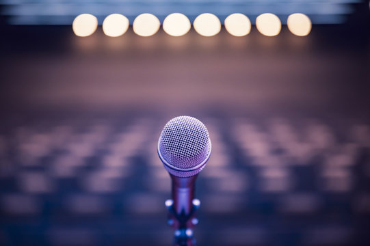 Microphone over the blurred business forum Meeting or Conference Room Concept, Blurred background.
