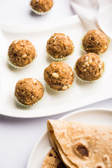Leftover chapati Laddu / Churma Laddoo or Policha Ladu made with Roti, peanuts, dry fruits and jaggery. selective focus 