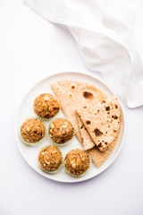 Leftover chapati Laddu / Churma Laddoo or Policha Ladu made with Roti, peanuts, dry fruits and jaggery. selective focus 
