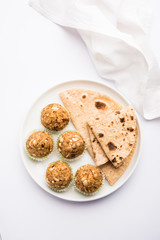Leftover chapati Laddu / Churma Laddoo or Policha Ladu made with Roti, peanuts, dry fruits and jaggery. selective focus 
