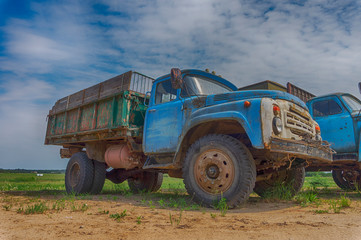 Old rusting truck or lorry outdoors in a field