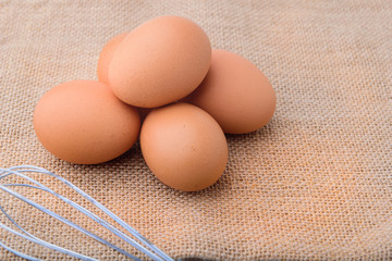 Fresh eggs on sackcloth. Copy the area for the text on the background, sackcloth, brown.