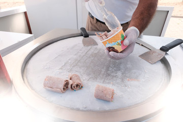 Detail of chocolate biscuit rolled ice cream on cold plate.