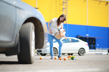 Pregnant woman with shopping comes from the store
