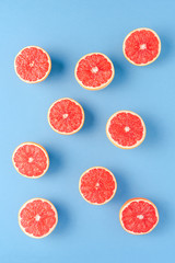 Juicy grapefruit halves on blue table. Top view