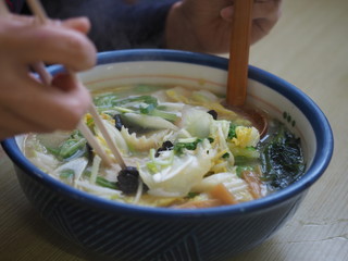 Traditional delicious ramen soup cooked with miso paste in Hokkaido, Japan with pork, seaweed and onion