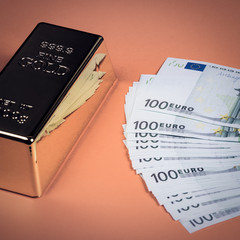 Euro cash and gold bar on a orange background. Banknotes. Money. Bill. Ingot. Bullion.