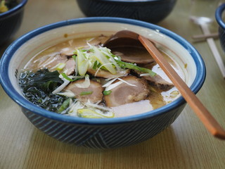 Traditional delicious ramen soup cooked with miso paste in Hokkaido, Japan with pork, seaweed and onion