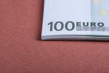 Fototapeta na wymiar Euro cash on a pink and brown background. Euro Money Banknotes. Euro Money. Euro bill. Place for text.