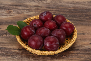 Plum heap in the wooden basket