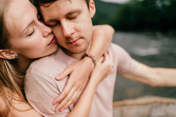 Lifestyle loving couple hugging at nature