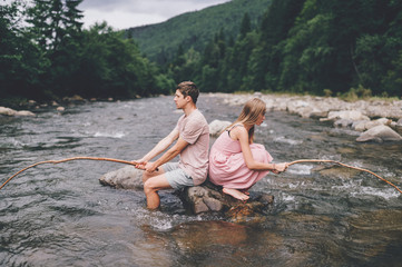 Funny couple fishing in the river.