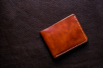 Genuine leather wallet handmade on leather background