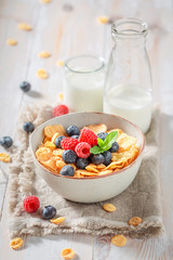 Delicious cornflakes with berries and milk for breakfast