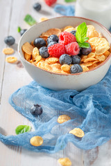 Sweet cornflakes with berries and milk as healthy meal