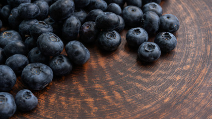 Blueberries and blueberries on the background of pottery. Black berries.