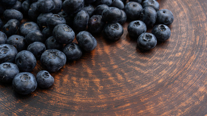 Blueberries and blueberries on the background of pottery. Black berries.