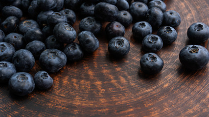 Blueberries and blueberries on the background of pottery. Black berries.
