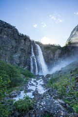 The 218 metre high Feigefossen (Feigumfossen) waterfall in an idyllic setting on the southern side of the Lusterfjord. Magnificent view  early midsummer morning in Norway.
