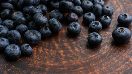 Blueberries and blueberries on the background of pottery. Black berries.