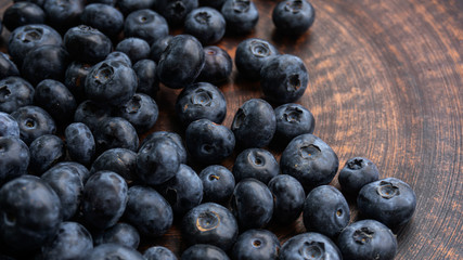 Blueberries and blueberries on the background of pottery. Black berries.