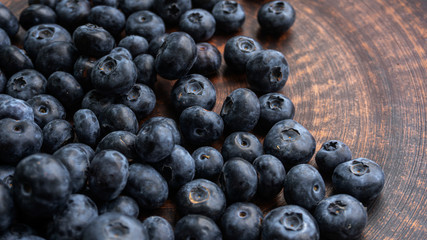Blueberries and blueberries on the background of pottery. Black berries.