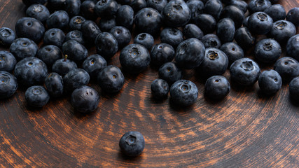 Blueberries and blueberries on the background of pottery. Black berries.