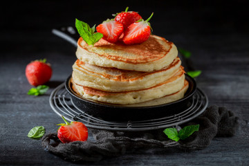 Homemade american pancakes with fresh sweet strawberries and sugar