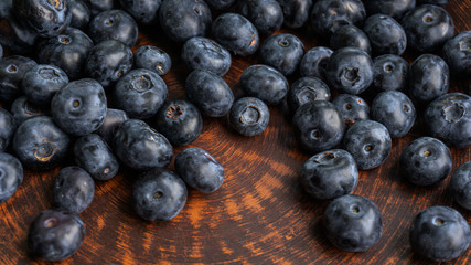Blueberries and blueberries on the background of pottery. Black berries.