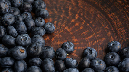 Blueberries and blueberries on the background of pottery. Black berries.