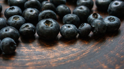 Blueberries and blueberries on the background of pottery. Black berries.