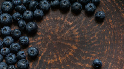 Blueberries and blueberries on the background of pottery. Black berries.